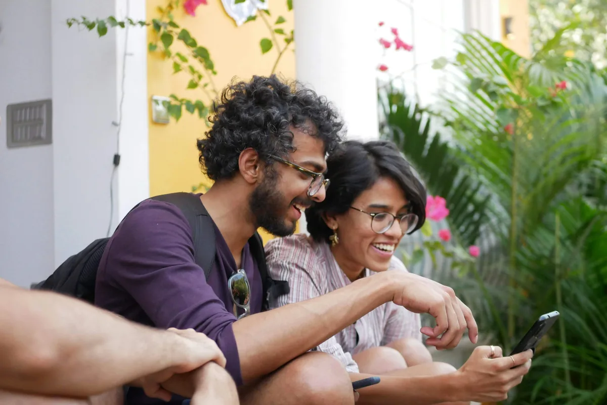 Two friends reading on a phone together