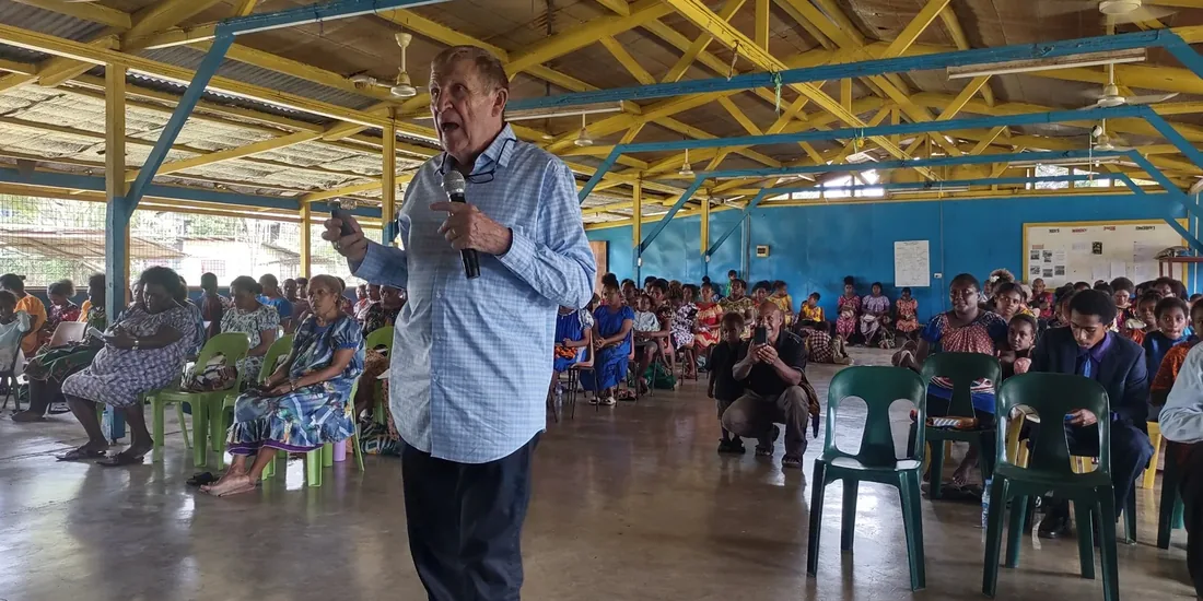 Herb Johnson preaching to a full hall in Lae, Papua New Guinea