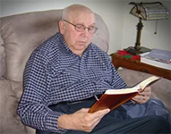 Papa reading his Bible in his armchair